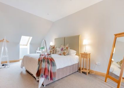 The bright double bedroom in The Tack Room accommodation at Woodside in Fife