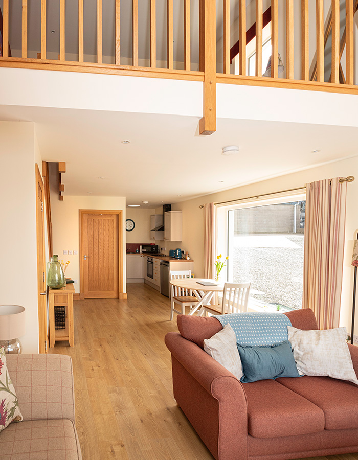 The open plan living and mezzanine in The Granary accommodation at Woodside in Fife