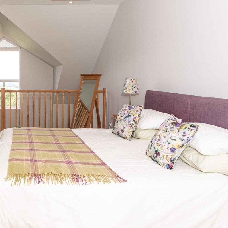 A mezzanine bedroom in The Hayloft accommodation at Woodside in Fife