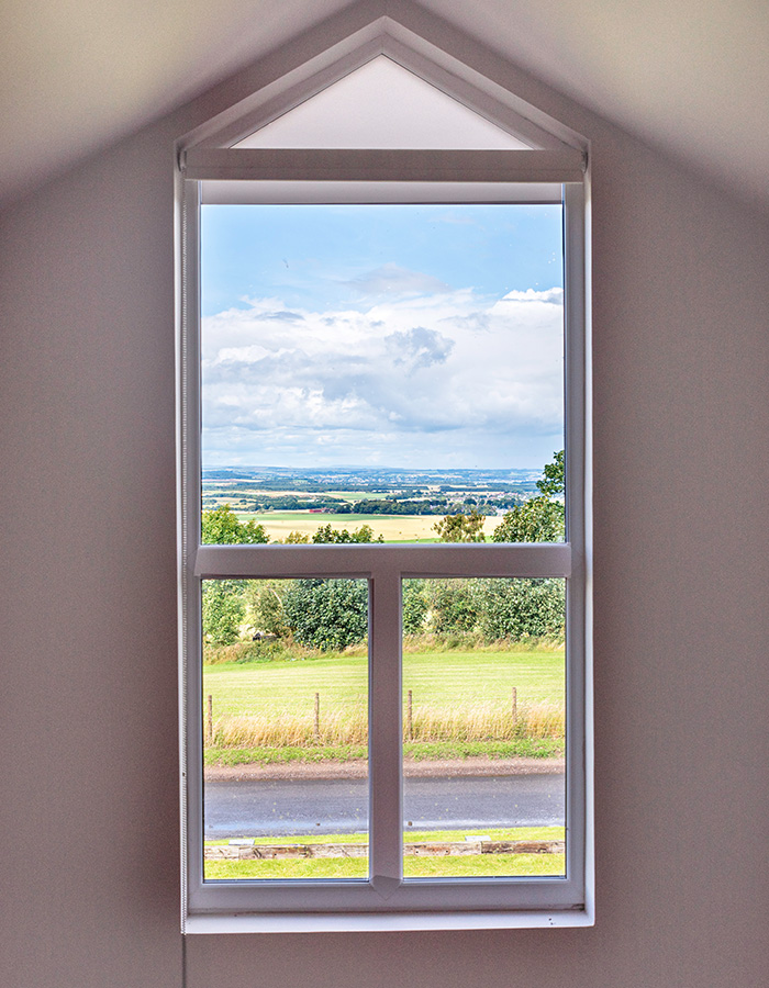 The view of the countryside from the window on the mezzanine in The Tack Room accommodation at Woodside in Fife