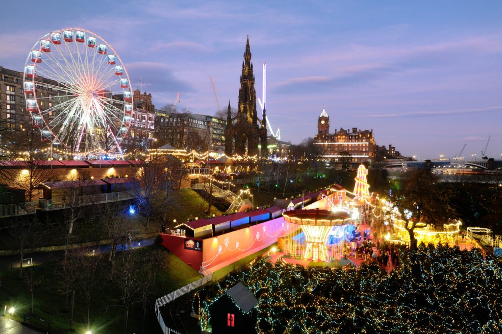 Edinburgh christmas market with ferris wheel and crowds of people