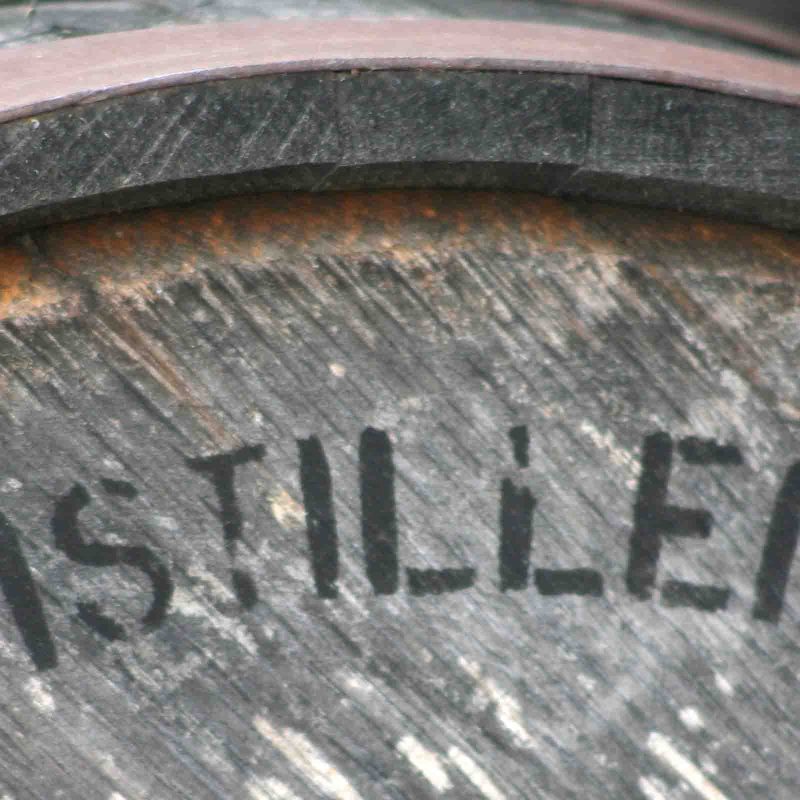 A barrell with the word 'DISTILLERY' printed on the side.