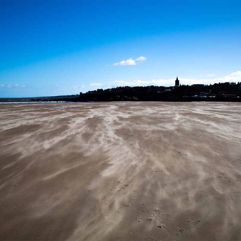 Sand blowing across West Sands Beach in St Andrews