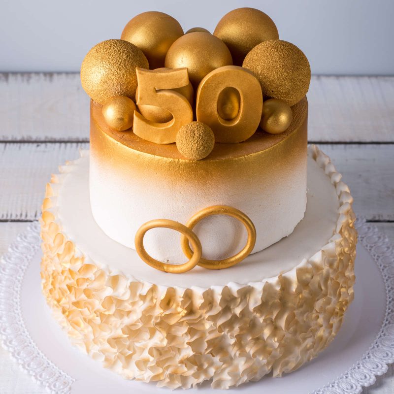 50th wedding anniversary cake with gold decorations